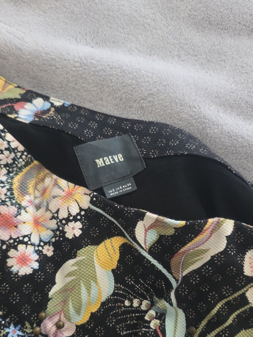 Maeve Black Floral Print Half Shoulder Dress with Pastel Blooms With Gold Studs.